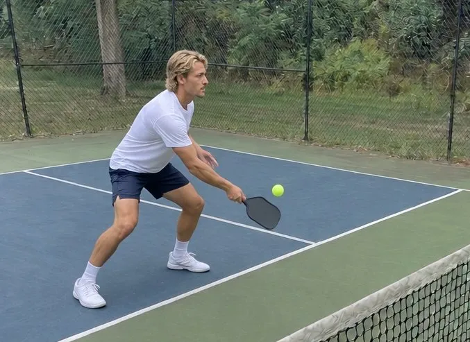 Jake playing a soft dink near the net; AI-generated demonstration image